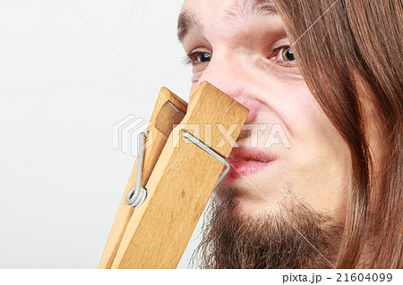Man with clothespin on nose 21604099