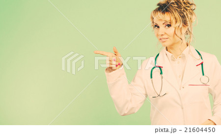 Female doctor showing copy space. Female doctor showing copy space. 21604450
