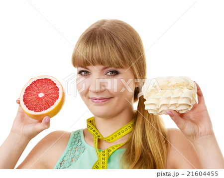 Woman choosing fruit or cake make dietary choice Woman choosing fruit or cake make dietary choice 21604455