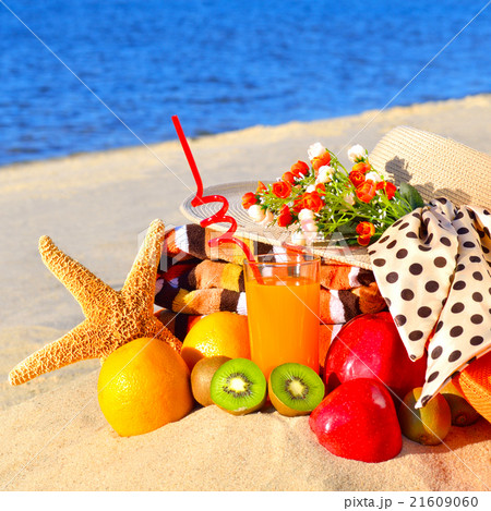 Woman hat, fruits, starfish, juice on beach Woman hat, fruits, starfish, juice on beach 21609060