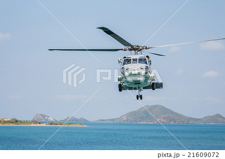 Helicopter flying over the sea 21609072