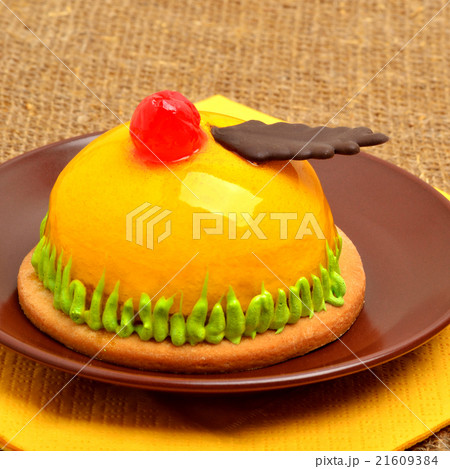 cake, tart with cherry on ceramic saucer  21609384