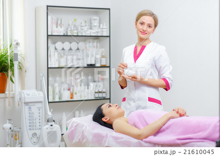 Young woman beautician is doing the cleaning Young woman beautician is doing the cleaning 21610045