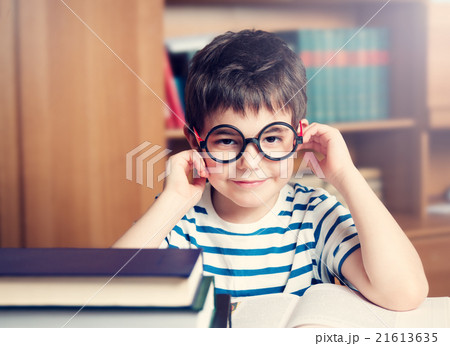 seven years old child reading a book 21613635