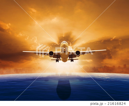 passenger jet plane flying over beautiful sea 21616824