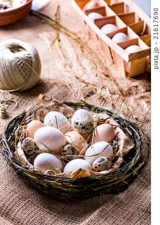 Fresh chicken and quail eggs in a nest 21617690