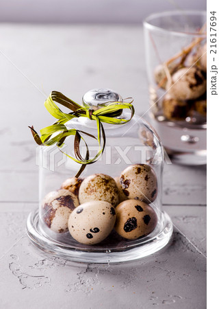 Quail's eggs under a glass cloche with a ribbon Quail's eggs under a glass cloche with a ribbon 21617694