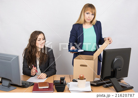 Office staff member with a smile watching charges fired colleagu Office staff member with a smile watching charges fired colleagu 21620787
