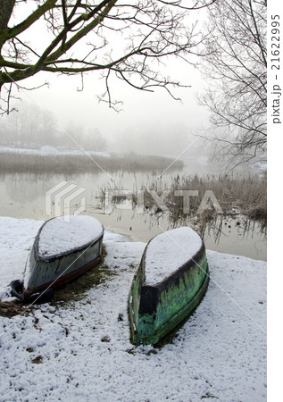 Two upturned boats on winter snow Two upturned boats on winter snow 21622995