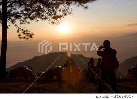 Campers taking picture of sunrise with smart phone Campers taking picture of sunrise with smart phone 21624017