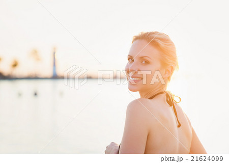 Attractive woman in bikini at the shore near Attractive woman in bikini at the shore near 21624099
