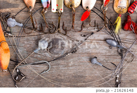 fishing tackles and spoon on wooden 21626148