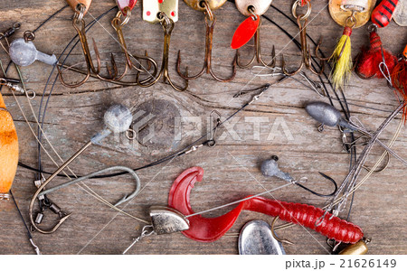 fishing tackles and spoon on wooden 21626149