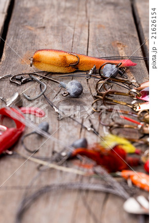 fishing tackles and spoon on wooden 21626154
