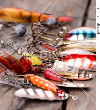 fishing tackles and spoon on wooden 21626156