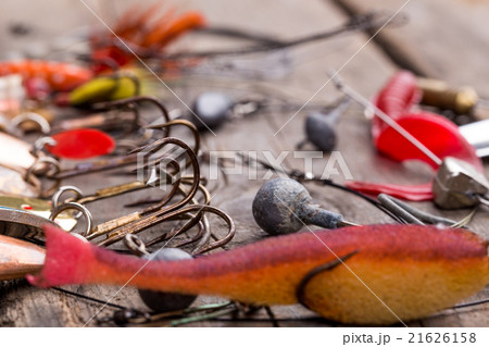 fishing tackles and spoon on wooden 21626158