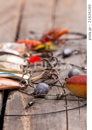 fishing tackles and spoon on wooden 21626160