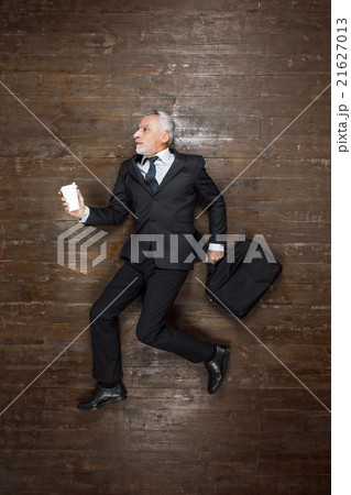 Top view photo of senior businessman on wooden Top view photo of senior businessman on wooden 21627013