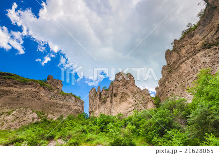 mountain cliffs and cloudy sky 21628065