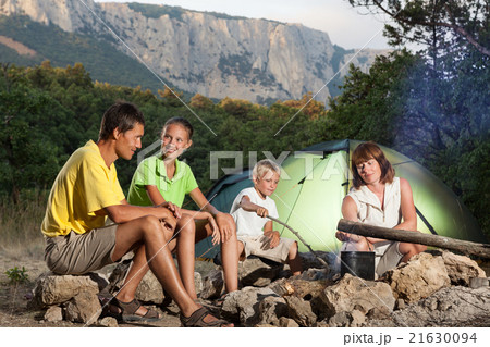 Family near campfire Family near campfire 21630094