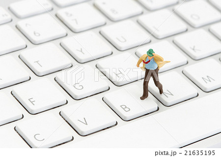 businessman running on a computer keyboard 21635195