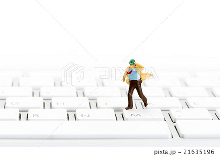businessman running on a computer keyboard 21635196