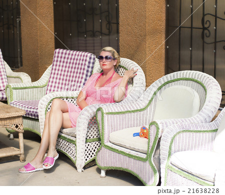 the woman in the pink has a rest in a chair 21638228