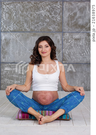 Pregnant girl is doing meditation at home Pregnant girl is doing meditation at home 21638975