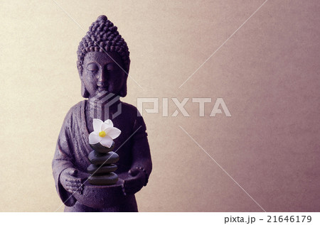 Buddha statue on a beige background with flower Buddha statue on a beige background with flower 21646179