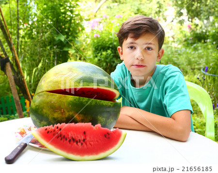preteen handsome boy with water melon 21656185
