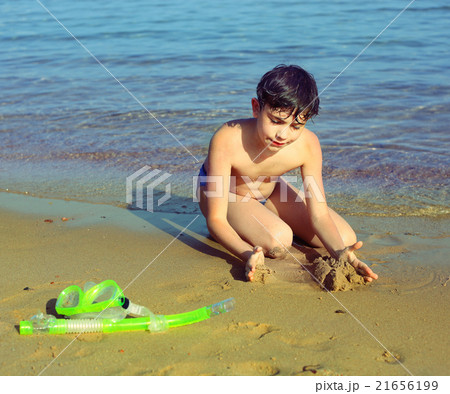 boy on the beach take sun bathing play with sand boy on the beach take sun bathing play with sand 21656199