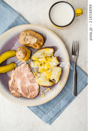 Baked potatoes with meat and pickles on the plate 21658899