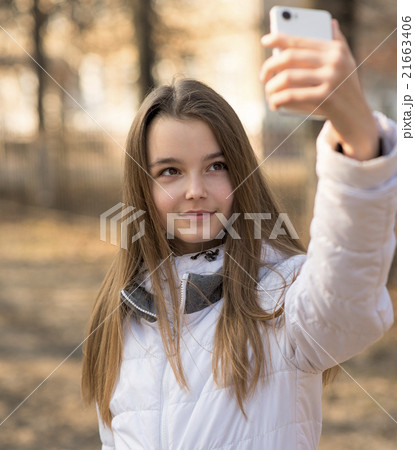 Beautiful girl takes a picture of the self 21663406