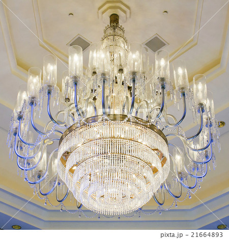 shining chandelier hanging on a ceiling in hotel shining chandelier hanging on a ceiling in hotel 21664893