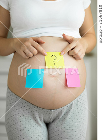 pregnant woman with pink and blue sticker on belly pregnant woman with pink and blue sticker on belly 21667810