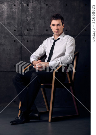 Portrait of successful businessman on a chair 21668625