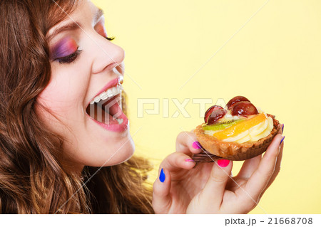Closeup woman eating fruit cake sweet food Closeup woman eating fruit cake sweet food 21668708