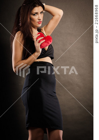 Beautiful woman holds red heart on black Beautiful woman holds red heart on black 21668968