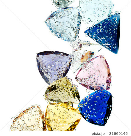Multi-colored gems falling into water isolated 21669146