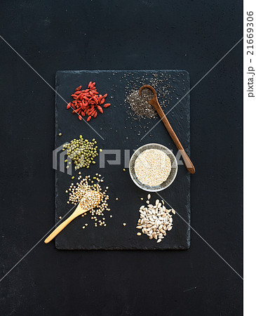 Superfoods on black chalkboard background: goji 21669306