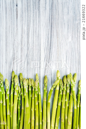 Green fresh sparagus on light painted wooden 21669322