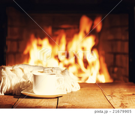 White cup of tea or coffee and woolen scarf White cup of tea or coffee and woolen scarf 21679905