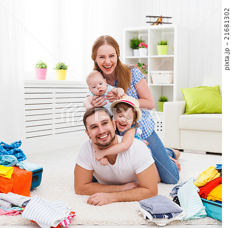 happy family mother, father and two children packed suitcases fo happy family mother, father and two children packed suitcases fo 21681302