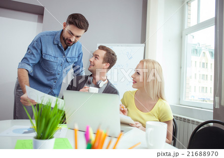 Cheerful creative team is discussing their work Cheerful creative team is discussing their work 21688970