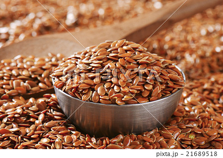 Brown flax seeds background 21689518