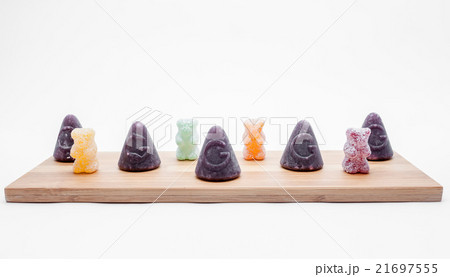 Cuberdons and sour bears on an plank 21697555