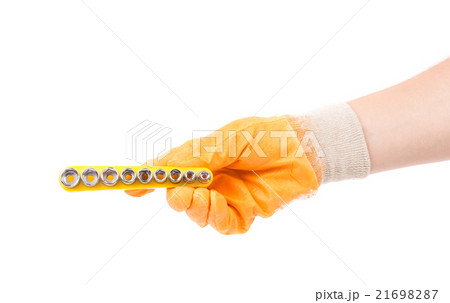Hand in gloves holding nozzles for screwdriver. 21698287