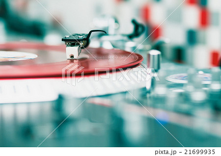 Turntable playing vinyl disc with music 21699935