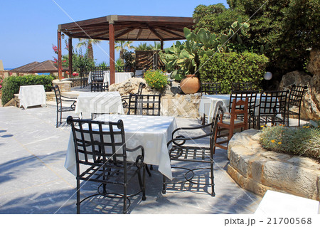Tables and iron chairs beautiful garden, Crete 21700568