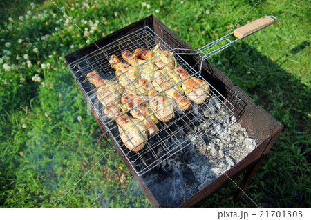 Barbecue with chicken in metal grate Barbecue with chicken in metal grate 21701303
